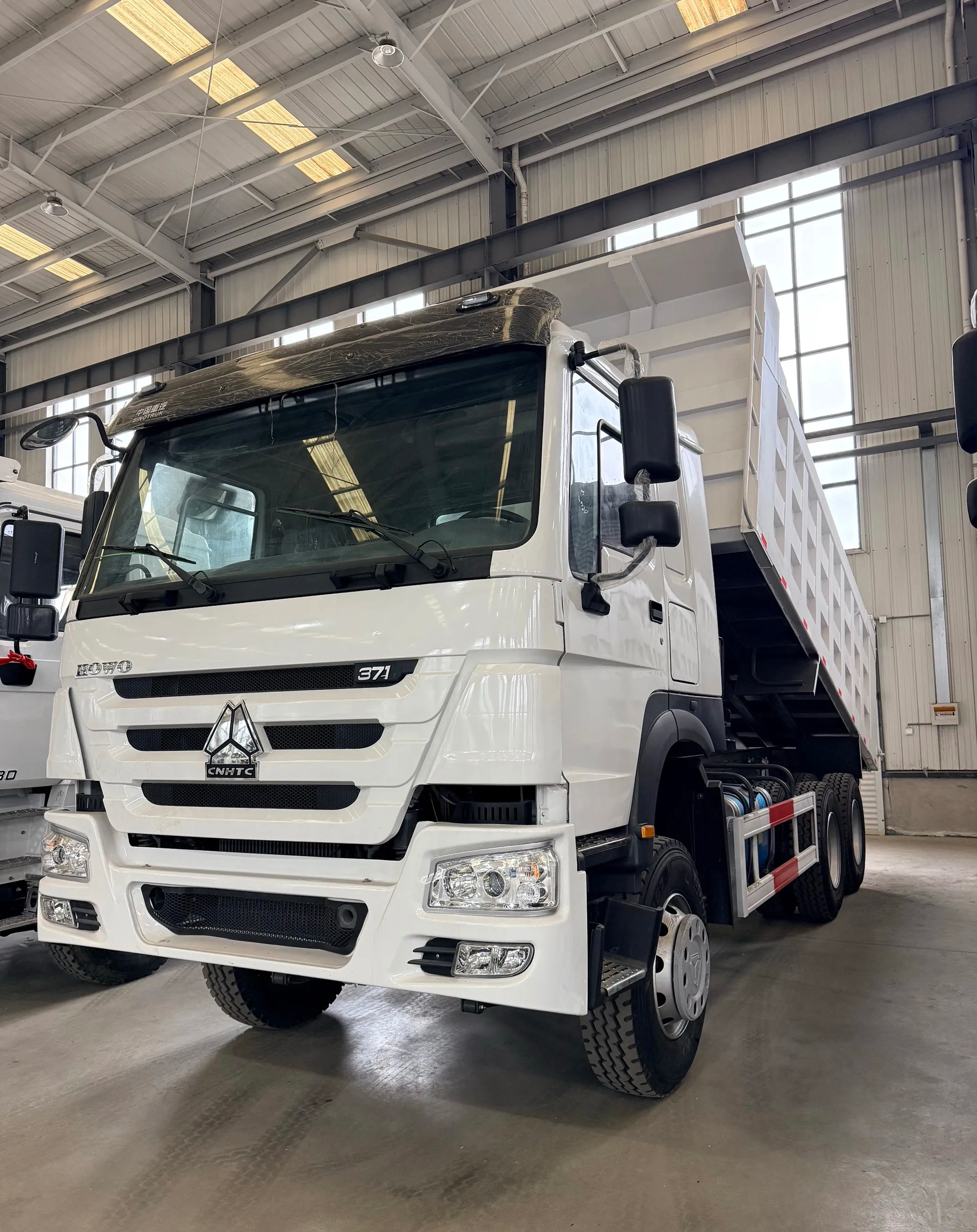 White HOWO 371 dump truck photographed indoors